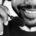 Alt text for web: Bearded man smiling while wearing a headset with a microphone near his mouth.